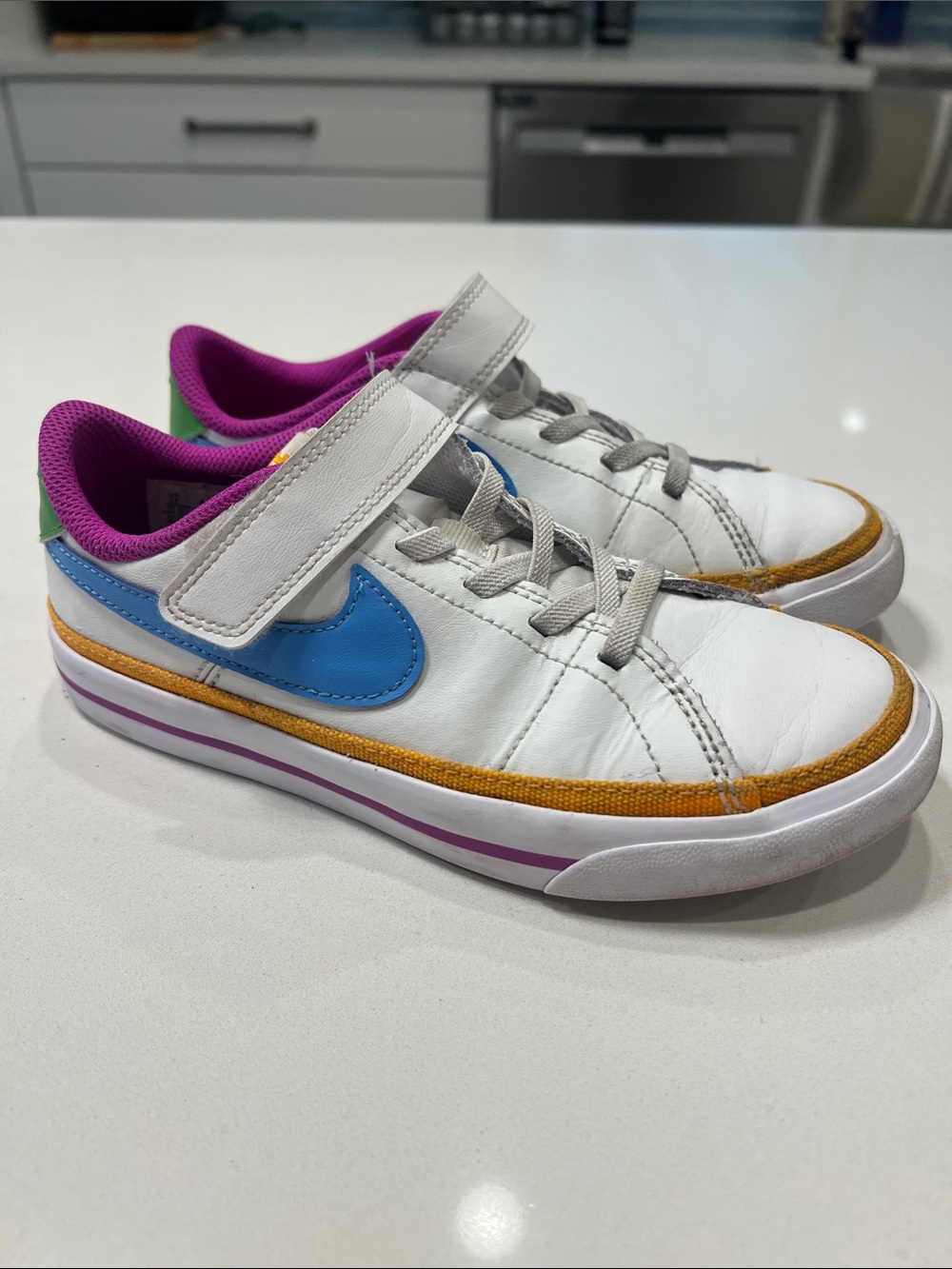 Nike Kids White Sneakers with Blue Swoosh and Purple Lining